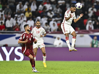 Mohammed Waad of Qatar battles for the ball with Harib Abdalla of the United Arab Emirates during the qualification 3rd round for the FIFA W...