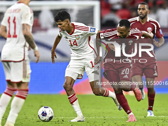 Ahmed Fathy of Qatar battles for the ball with Abdulla Almenhali of the United Arab Emirates during the qualification 3rd round for the FIFA...