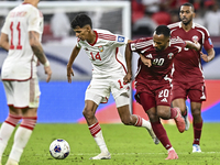 Ahmed Fathy of Qatar battles for the ball with Abdulla Almenhali of the United Arab Emirates during the qualification 3rd round for the FIFA...