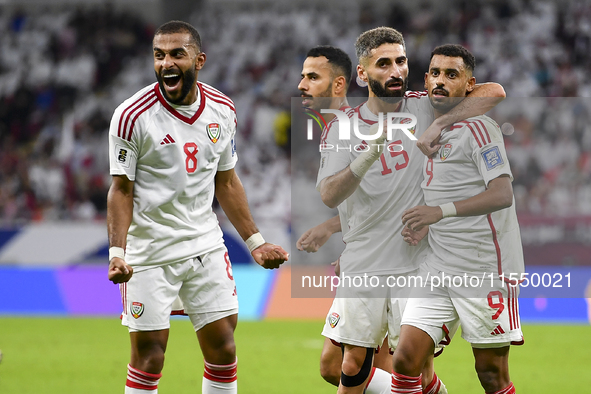 Harib Abdalla (R) of the United Arab Emirates celebrates with his teammate after scoring during the qualification 3rd round for the FIFA Wor...