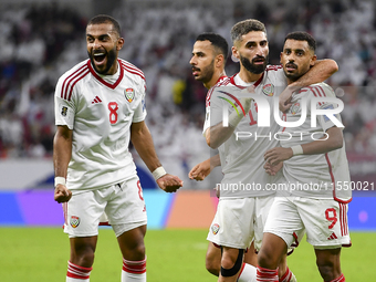 Harib Abdalla (R) of the United Arab Emirates celebrates with his teammate after scoring during the qualification 3rd round for the FIFA Wor...