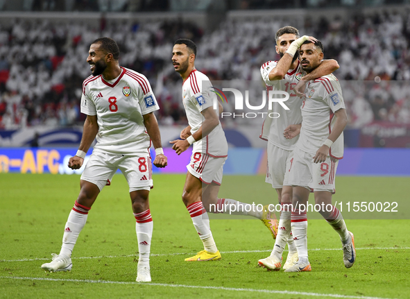 Harib Abdalla (R) of the United Arab Emirates celebrates with his teammate after scoring during the qualification 3rd round for the FIFA Wor...