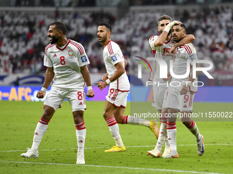 Harib Abdalla (R) of the United Arab Emirates celebrates with his teammate after scoring during the qualification 3rd round for the FIFA Wor...