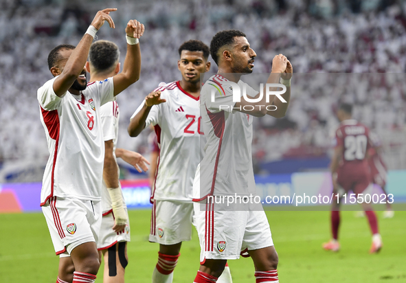 Harib Abdalla (R) of the United Arab Emirates celebrates with his teammate after scoring during the qualification 3rd round for the FIFA Wor...