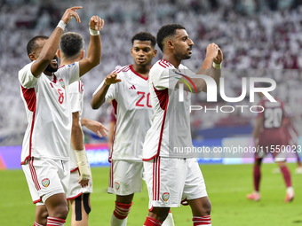 Harib Abdalla (R) of the United Arab Emirates celebrates with his teammate after scoring during the qualification 3rd round for the FIFA Wor...