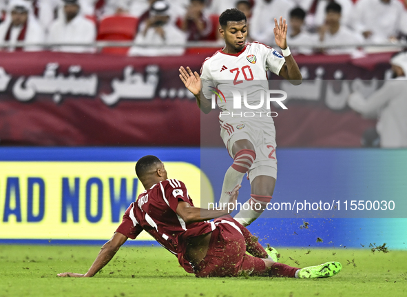 Pedro Correia of Qatar battles for the ball with Yahya Alghassani of the United Arab Emirates during the qualification 3rd round for the FIF...