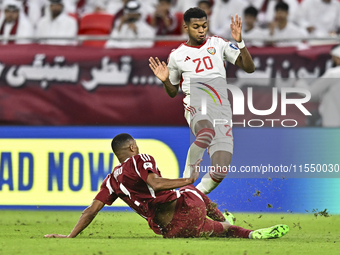 Pedro Correia of Qatar battles for the ball with Yahya Alghassani of the United Arab Emirates during the qualification 3rd round for the FIF...