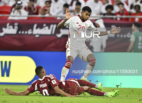 Pedro Correia of Qatar battles for the ball with Yahya Alghassani of the United Arab Emirates during the qualification 3rd round for the FIF...