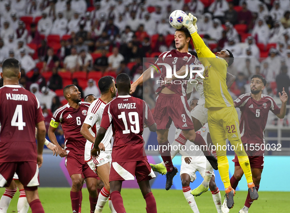 Meshaal Barsham (#22) of Qatar battles for the ball with Kouame Kouadio (#4) of United Arab Emirates during the qualification 3rd round for...