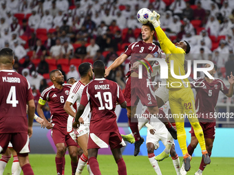 Meshaal Barsham (#22) of Qatar battles for the ball with Kouame Kouadio (#4) of United Arab Emirates during the qualification 3rd round for...