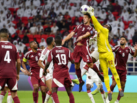 Meshaal Barsham (#22) of Qatar battles for the ball with Kouame Kouadio (#4) of United Arab Emirates during the qualification 3rd round for...