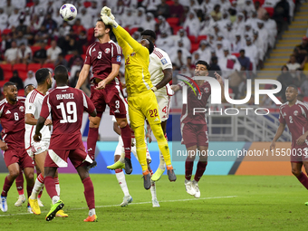 Meshaal Barsham (#22) of Qatar battles for the ball with Kouame Kouadio (#4) of United Arab Emirates during the qualification 3rd round for...