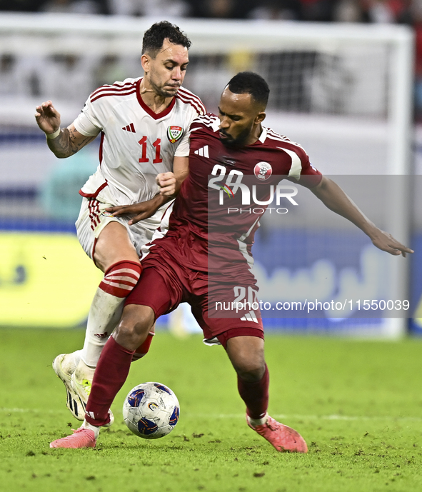 Ahmed Fathy (R) of Qatar battles for the ball with Caio Correa (L) of the United Arab Emirates during the qualification 3rd round for the FI...