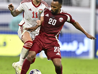 Ahmed Fathy (R) of Qatar battles for the ball with Caio Correa (L) of the United Arab Emirates during the qualification 3rd round for the FI...