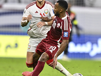 Ahmed Fathy (R) of Qatar battles for the ball with Caio Correa (L) of the United Arab Emirates during the qualification 3rd round for the FI...