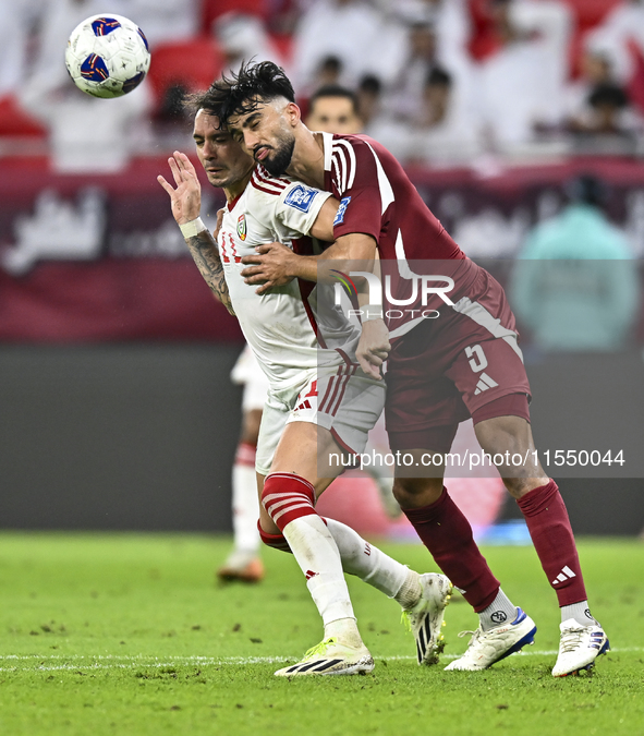 Tarek Salman (R) of Qatar battles for the ball with Caio Correa (L) of the United Arab Emirates during the qualification 3rd round for the F...