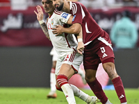 Tarek Salman (R) of Qatar battles for the ball with Caio Correa (L) of the United Arab Emirates during the qualification 3rd round for the F...