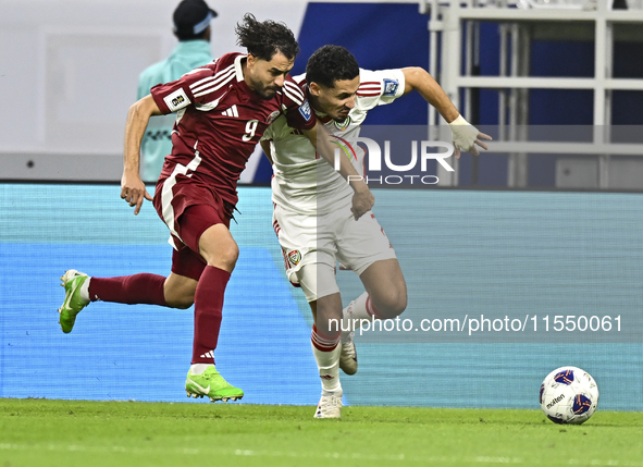 Abdelrahman Fahmi (L) of Qatar battles for the ball with Ali Saleh Amro (R) of the United Arab Emirates during the qualification 3rd round f...