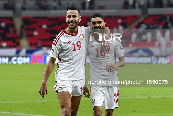 Khaled Aldhanhani (L) and Mohammed Abbas (R) of the United Arab Emirates celebrate after winning the qualification 3rd round for the FIFA Wo...