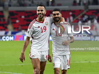 Khaled Aldhanhani (L) and Mohammed Abbas (R) of the United Arab Emirates celebrate after winning the qualification 3rd round for the FIFA Wo...