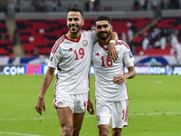 Khaled Aldhanhani (L) and Mohammed Abbas (R) of the United Arab Emirates celebrate after winning the qualification 3rd round for the FIFA Wo...