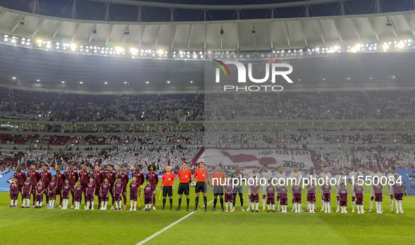 Qatar (L) and United Arab Emirates (R) teams line up prior to the qualification 3rd round for the FIFA World Cup 2026 group A match between...