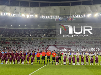 Qatar (L) and United Arab Emirates (R) teams line up prior to the qualification 3rd round for the FIFA World Cup 2026 group A match between...