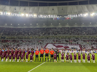 Qatar (L) and United Arab Emirates (R) teams line up prior to the qualification 3rd round for the FIFA World Cup 2026 group A match between...