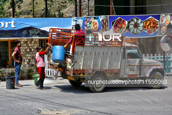 Workers collect trash from a restaurant and hotel in Mussoorie, Uttarakhand, India, on April 18, 2024. 