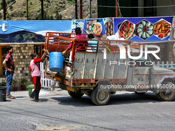 Workers collect trash from a restaurant and hotel in Mussoorie, Uttarakhand, India, on April 18, 2024. (