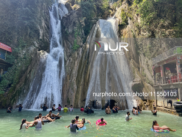 Indian tourists enjoy the cool water at Kempty Falls near the town of Mussoorie, Uttarakhand, India, on April 18, 2024. Kempty Falls is well...