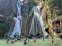 Indian tourists enjoy the cool water at Kempty Falls near the town of Mussoorie, Uttarakhand, India, on April 18, 2024. Kempty Falls is well...