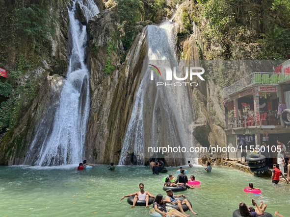 Indian tourists enjoy the cool water at Kempty Falls near the town of Mussoorie, Uttarakhand, India, on April 18, 2024. Kempty Falls is well...