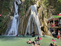 Indian tourists enjoy the cool water at Kempty Falls near the town of Mussoorie, Uttarakhand, India, on April 18, 2024. Kempty Falls is well...