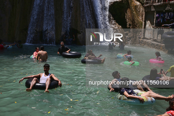 Indian tourists enjoy the cool water at Kempty Falls near the town of Mussoorie, Uttarakhand, India, on April 18, 2024. Kempty Falls is well...