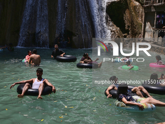 Indian tourists enjoy the cool water at Kempty Falls near the town of Mussoorie, Uttarakhand, India, on April 18, 2024. Kempty Falls is well...