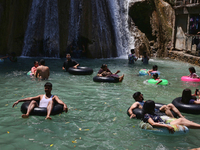 Indian tourists enjoy the cool water at Kempty Falls near the town of Mussoorie, Uttarakhand, India, on April 18, 2024. Kempty Falls is well...