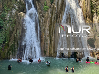 Indian tourists enjoy the cool water at Kempty Falls near the town of Mussoorie, Uttarakhand, India, on April 18, 2024. Kempty Falls is well...