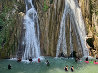 Indian tourists enjoy the cool water at Kempty Falls near the town of Mussoorie, Uttarakhand, India, on April 18, 2024. Kempty Falls is well...