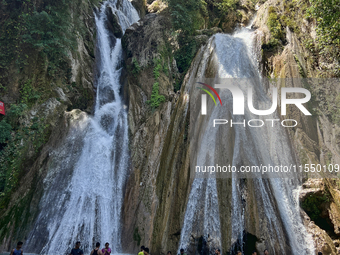 Indian tourists enjoy the cool water at Kempty Falls near the town of Mussoorie, Uttarakhand, India, on April 18, 2024. Kempty Falls is well...