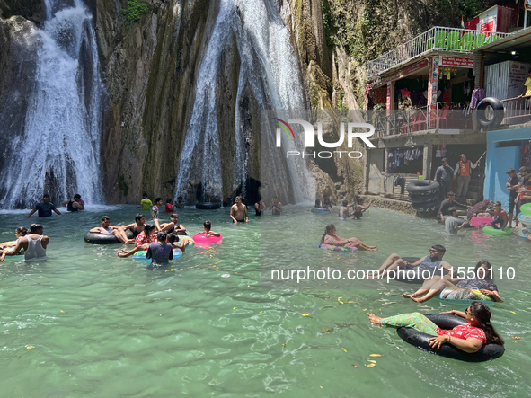 Indian tourists enjoy the cool water at Kempty Falls near the town of Mussoorie, Uttarakhand, India, on April 18, 2024. Kempty Falls is well...