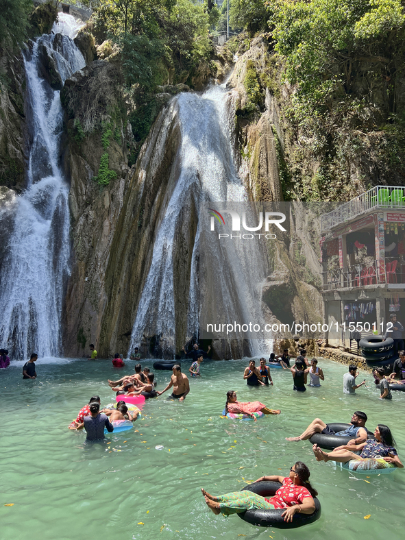 Indian tourists enjoy the cool water at Kempty Falls near the town of Mussoorie, Uttarakhand, India, on April 18, 2024. Kempty Falls is well...