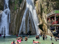 Indian tourists enjoy the cool water at Kempty Falls near the town of Mussoorie, Uttarakhand, India, on April 18, 2024. Kempty Falls is well...