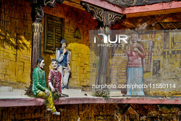 An artistic display depicts Kumaon villagers in a traditional home along the Mall Road in Mussoorie, Uttarakhand, India, on April 18, 2024. 