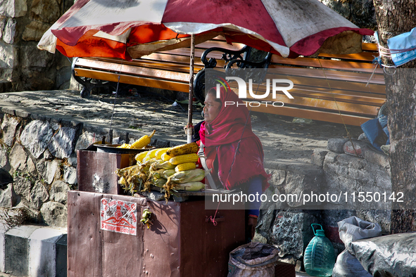 A woman sells corn along the Mall Road in Mussoorie, Uttarakhand, India, on April 18, 2024. 