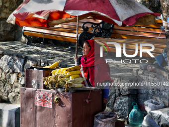 A woman sells corn along the Mall Road in Mussoorie, Uttarakhand, India, on April 18, 2024. (