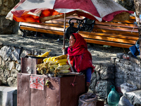 A woman sells corn along the Mall Road in Mussoorie, Uttarakhand, India, on April 18, 2024. (