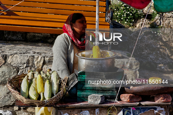 A woman sells corn along the Mall Road in Mussoorie, Uttarakhand, India, on April 18, 2024. 