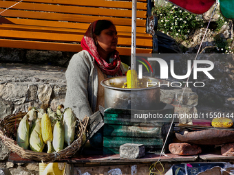 A woman sells corn along the Mall Road in Mussoorie, Uttarakhand, India, on April 18, 2024. (