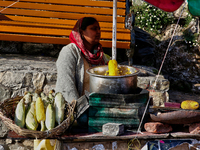 A woman sells corn along the Mall Road in Mussoorie, Uttarakhand, India, on April 18, 2024. (